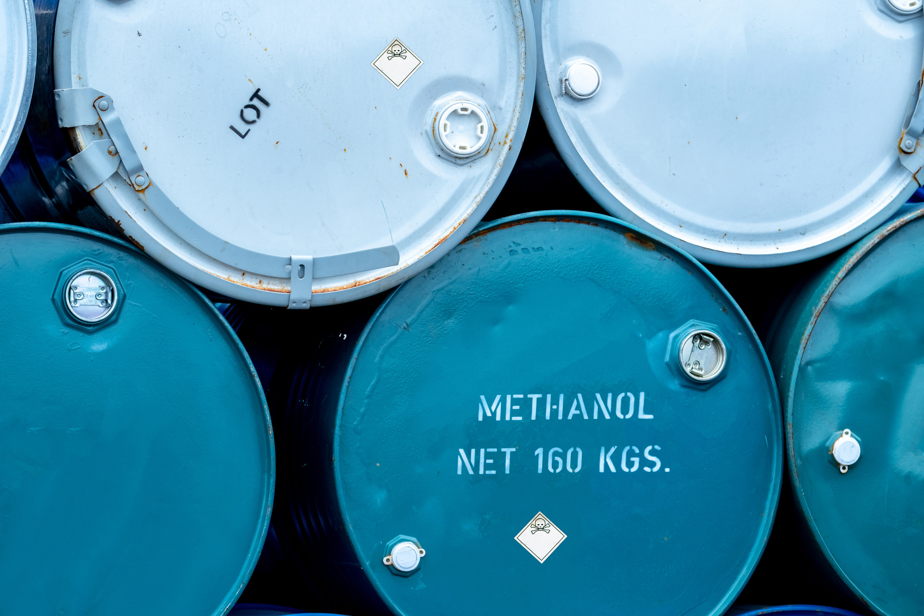 Old chemical barrels. Stack of blue methanol or methyl alcohol d